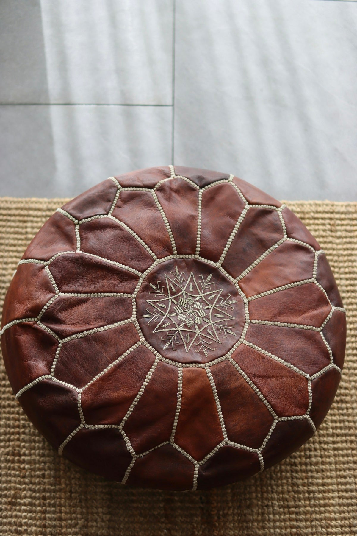 Hand-stitched Moroccan leather pouf ottoman